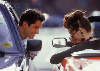 Young man in a car and young woman in a convertible --- Image by © Targa/Corbis