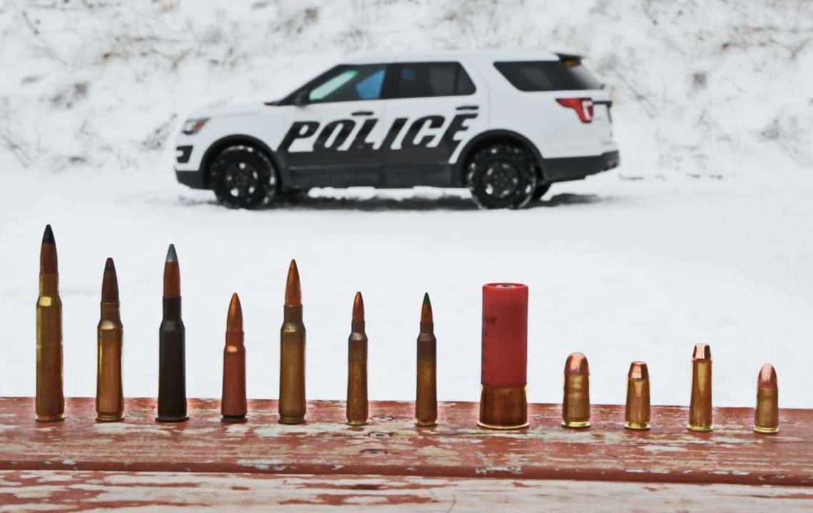 In this March 3, 2016, photo provided by Ford Motor Company, different types of ammunition used in testing are displayed, foreground, as a Ford Police Interceptor Utility vehicle sits parked in the background during ballistic testing of doors against small arm fire at the Livingston Conservation and Sports Association in Brighton, Mich. Ford will soon be offering doors on its Police Interceptor sedans and SUVs that can protect against armor-piercing bullets. They’ll be the first in the U.S. to meet the Justice Department’s highest standard for body armor, the equivalent of a bulky SWAT team vest. (Ryan Koehler/Ford Motor Company via AP) MANDATORY CREDIT