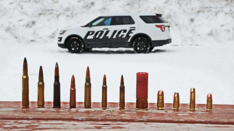 In this March 3, 2016, photo provided by Ford Motor Company, different types of ammunition used in testing are displayed, foreground, as a Ford Police Interceptor Utility vehicle sits parked in the background during ballistic testing of doors against small arm fire at the Livingston Conservation and Sports Association in Brighton, Mich. Ford will soon be offering doors on its Police Interceptor sedans and SUVs that can protect against armor-piercing bullets. They’ll be the first in the U.S. to meet the Justice Department’s highest standard for body armor, the equivalent of a bulky SWAT team vest. (Ryan Koehler/Ford Motor Company via AP) MANDATORY CREDIT
